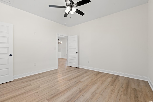 2428 Park St, North Myrtle Beach, SC 29582 - empty room with light wood-style floors, a ceiling fan, and a chandelier