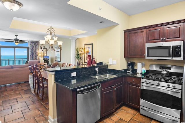100 N Beach Blvd Unit 1816, North Myrtle Beach, SC 29582 - kitchen with stainless steel appliances, a peninsula, open floor plan, and stone tile flooring