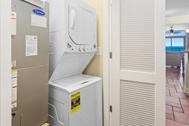 100 N Beach Blvd Unit 1816, North Myrtle Beach, SC 29582 - laundry room featuring estacked washer and dryer, brick floors, and a ceiling fan