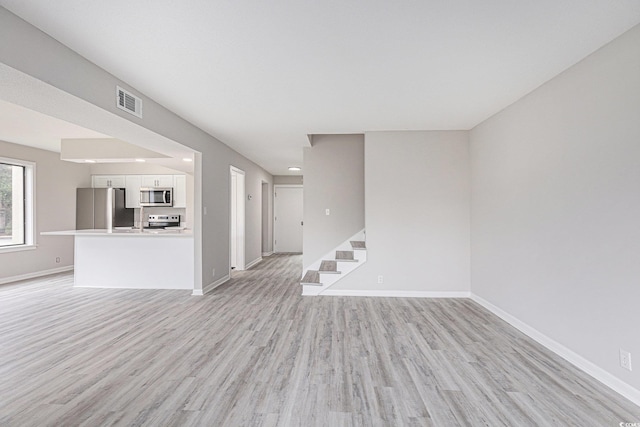 800 Egret Cir Unit 53, Little River, SC 29566 - unfurnished living room with light wood finished floors, stairs, and recessed lighting