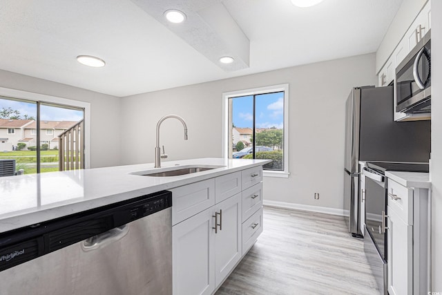 800 Egret Cir Unit 53, Little River, SC 29566 - kitchen with stainless steel appliances, white cabinets, recessed lighting, and light wood-type flooring