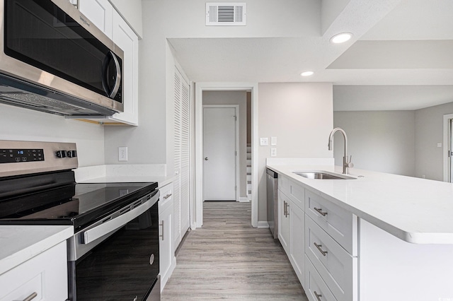 800 Egret Cir Unit 53, Little River, SC 29566 - kitchen with stainless steel appliances, recessed lighting, light countertops, and white cabinetry