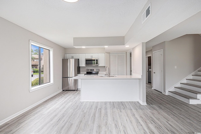 800 Egret Cir Unit 53, Little River, SC 29566 - kitchen with stainless steel appliances, light wood-style flooring, light countertops, white cabinets, and recessed lighting