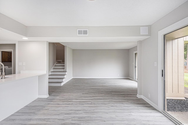 800 Egret Cir Unit 53, Little River, SC 29566 - unfurnished living room featuring stairs, plenty of natural light, light wood-style floors, and recessed lighting