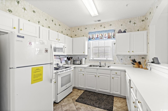5801 Oyster Catcher Dr Unit 431, North Myrtle Beach, SC 29582 - kitchen with white appliances, white cabinetry, wallpapered walls, light countertops, and light tile patterned floors