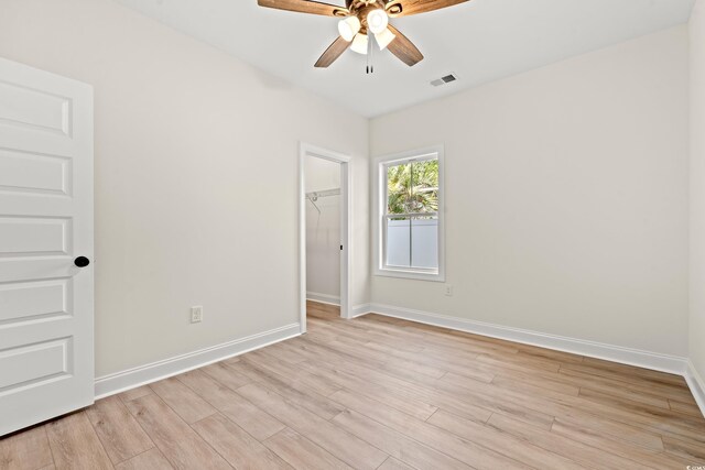 2426 Park St, North Myrtle Beach, SC 29582 - unfurnished bedroom featuring light wood-type flooring, a walk in closet, a closet, and ceiling fan