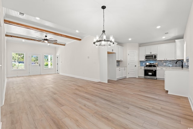 2426 Park St, North Myrtle Beach, SC 29582 - kitchen with appliances with stainless steel finishes, ceiling fan, a chandelier, open floor plan, and light countertops