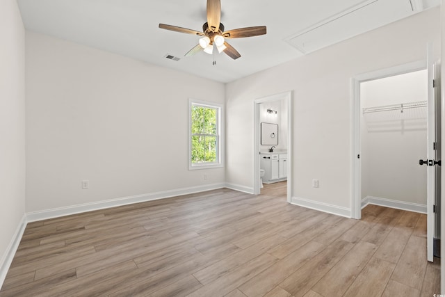 2426 Park St, North Myrtle Beach, SC 29582 - unfurnished bedroom featuring attic access, light wood-style flooring, a walk in closet, and ensuite bath