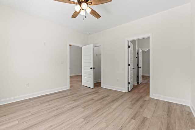 2426 Park St, North Myrtle Beach, SC 29582 - unfurnished bedroom featuring light wood-type flooring, a closet, a spacious closet, and a ceiling fan