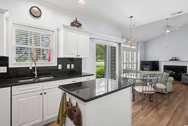 503 20th Ave N Unit 9D, North Myrtle Beach, SC 29582 - kitchen with dishwasher, a ceiling fan, white cabinetry, light wood finished floors, and a fireplace