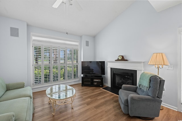 503 20th Ave N Unit 9D, North Myrtle Beach, SC 29582 - living room with wood finished floors, lofted ceiling, ceiling fan, and a fireplace with flush hearth