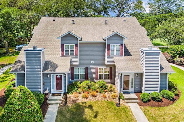 503 20th Ave N Unit 9D, North Myrtle Beach, SC 29582 - townhome / multi-family property with a chimney, a shingled roof, and a front lawn