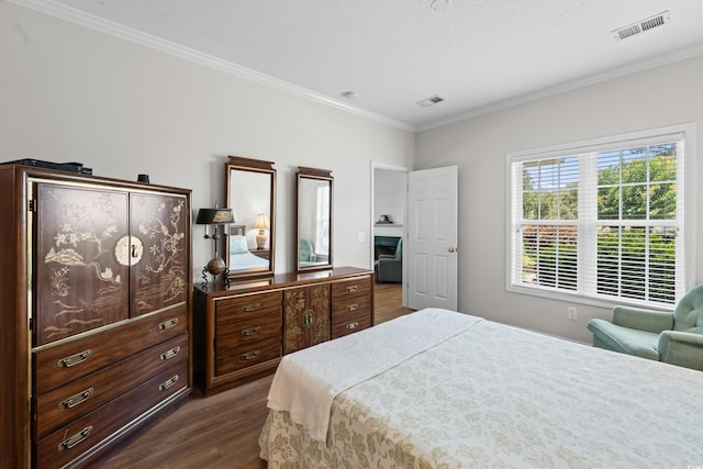 503 20th Ave N Unit 9D, North Myrtle Beach, SC 29582 - bedroom with dark wood-style flooring and crown molding