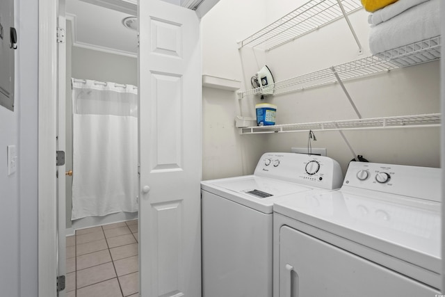 503 20th Ave N Unit 9D, North Myrtle Beach, SC 29582 - washroom with washer and dryer, light tile patterned floors, and crown molding