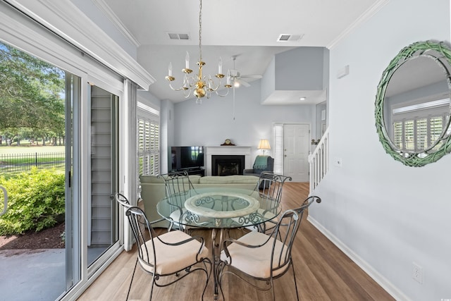 503 20th Ave N Unit 9D, North Myrtle Beach, SC 29582 - dining room with wood finished floors, a fireplace, a chandelier, ornamental molding, and stairway