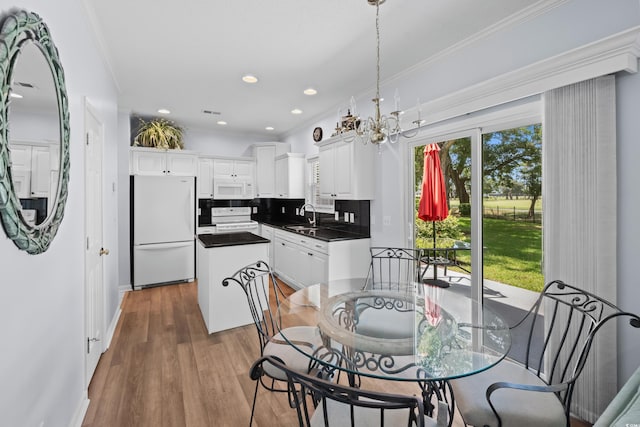 503 20th Ave N Unit 9D, North Myrtle Beach, SC 29582 - dining space with a chandelier, crown molding, wood finished floors, and recessed lighting