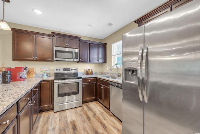 125 S Shore Dr Unit 204, Longs, SC 29568 - kitchen featuring stainless steel appliances, light wood finished floors, light stone countertops, recessed lighting, and dark brown cabinets