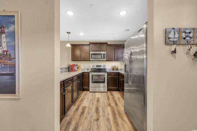 125 S Shore Dr Unit 204, Longs, SC 29568 - kitchen featuring appliances with stainless steel finishes, light wood finished floors, light stone countertops, recessed lighting, and dark brown cabinets