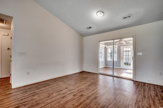 1836 Juniper Dr, Conway, SC 29527 - empty room with wood finished floors, a textured ceiling, and vaulted ceiling