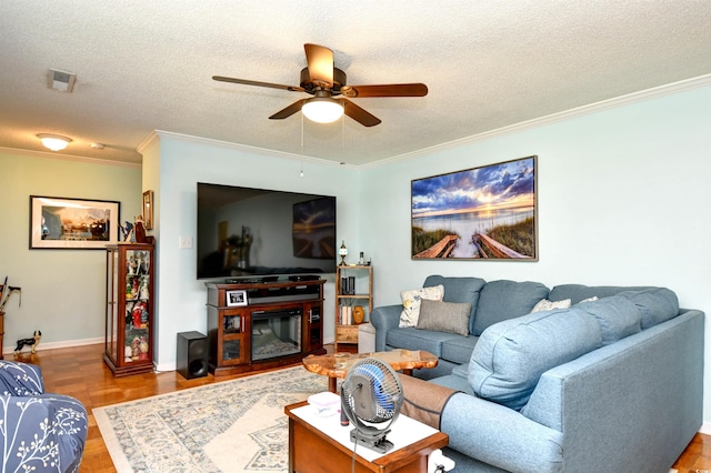 3602 Magnolia St Unit 3602, Myrtle Beach, SC 29577 - living area with ceiling fan, ornamental molding, a textured ceiling, and a glass covered fireplace
