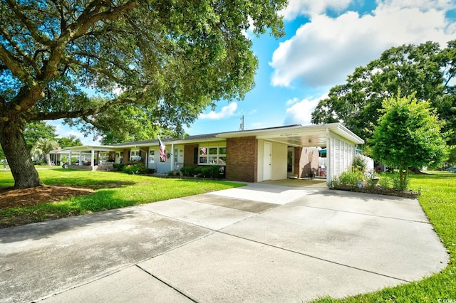 3602 Magnolia St Unit 3602, Myrtle Beach, SC 29577 - ranch-style house featuring a front yard, brick siding, driveway, and a carport