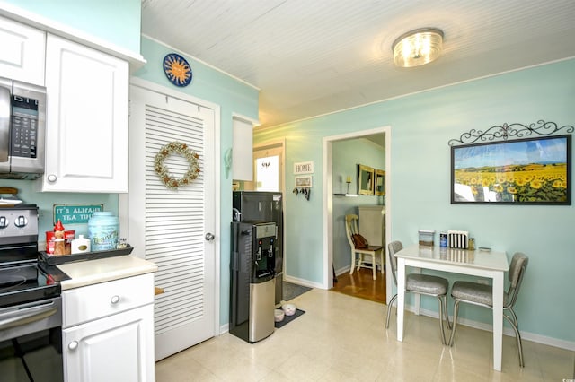 3602 Magnolia St Unit 3602, Myrtle Beach, SC 29577 - kitchen with appliances with stainless steel finishes, white cabinetry, and light countertops
