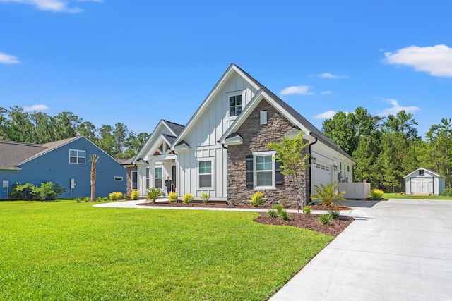 609 Mccown Dr, Conway, SC 29526 - view of front of home featuring board and batten siding, concrete driveway, an attached garage, a shed, and a front yard