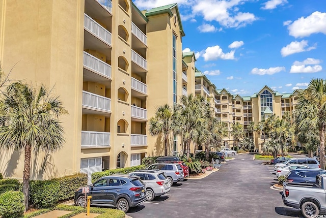 139 S Dunes Dr Unit 304, Pawleys Island, SC 29585 - view of apartment building / complex featuring uncovered parking