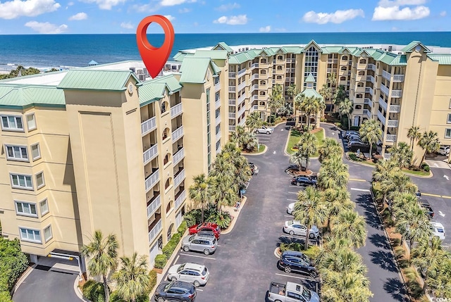 139 S Dunes Dr Unit 304, Pawleys Island, SC 29585 - view of apartment building / complex with uncovered parking and a water view