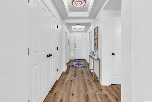 139 S Dunes Dr Unit 304, Pawleys Island, SC 29585 - hall featuring a tray ceiling, light wood-style floors, and crown molding