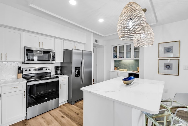 139 S Dunes Dr Unit 304, Pawleys Island, SC 29585 - kitchen with stainless steel appliances, a chandelier, tasteful backsplash, a center island, and white cabinetry