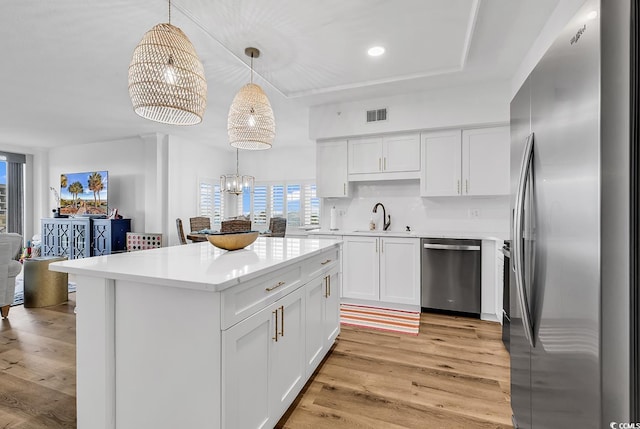 139 S Dunes Dr Unit 304, Pawleys Island, SC 29585 - kitchen featuring stainless steel appliances, light wood-type flooring, light countertops, and white cabinetry