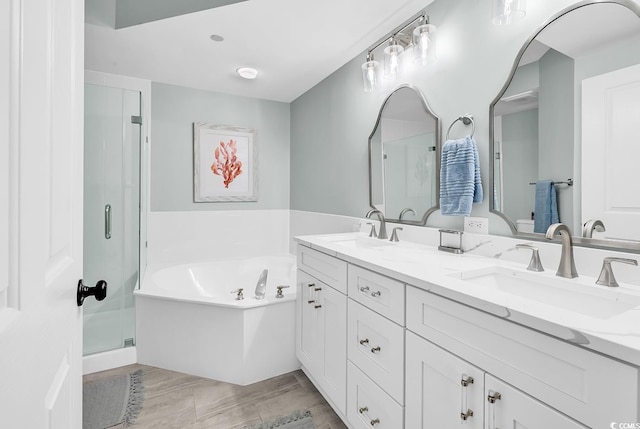 139 S Dunes Dr Unit 304, Pawleys Island, SC 29585 - full bathroom with double vanity, a garden tub, a stall shower, and wood finished floors
