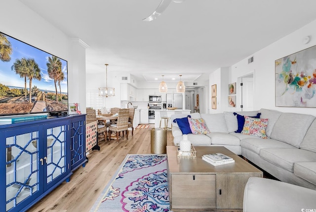 139 S Dunes Dr Unit 304, Pawleys Island, SC 29585 - living area featuring light wood-style floors and a chandelier