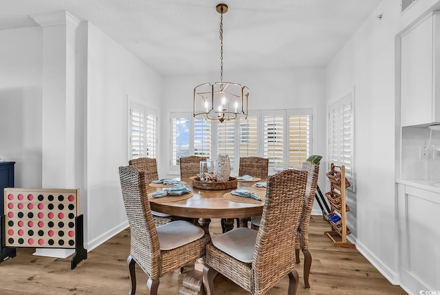 139 S Dunes Dr Unit 304, Pawleys Island, SC 29585 - dining area with light wood finished floors and a chandelier