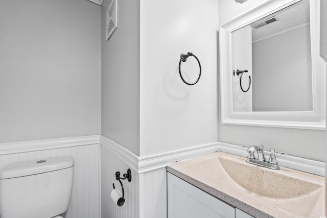 4115 Little River Rd Unit 1-E, Myrtle Beach, SC 29577 - half bathroom featuring a wainscoted wall and vanity