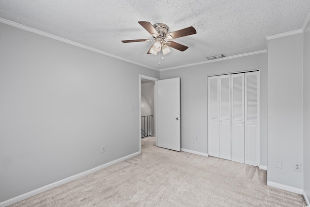 4115 Little River Rd Unit 1-E, Myrtle Beach, SC 29577 - unfurnished bedroom featuring carpet floors, a closet, ornamental molding, a ceiling fan, and a textured ceiling