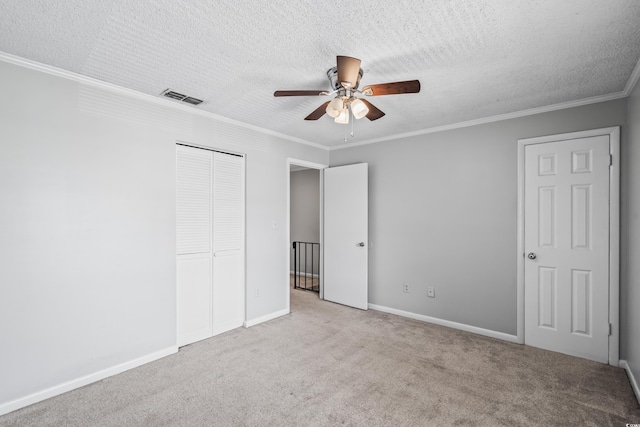 4115 Little River Rd Unit 1-E, Myrtle Beach, SC 29577 - unfurnished bedroom with carpet flooring, a closet, a textured ceiling, crown molding, and ceiling fan