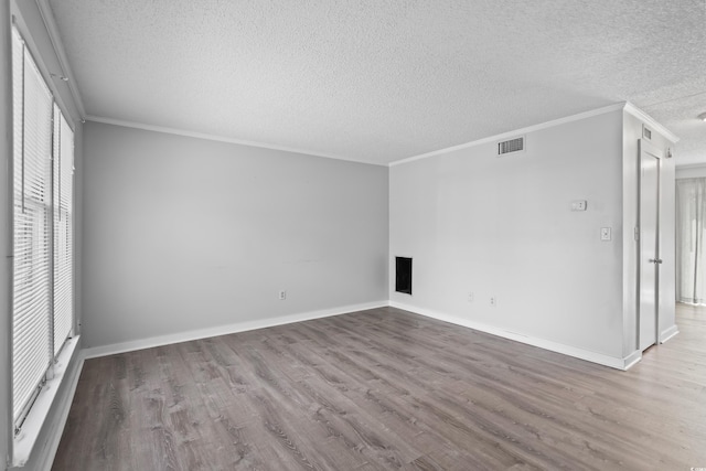 4115 Little River Rd Unit 1-E, Myrtle Beach, SC 29577 - spare room with a textured ceiling, wood finished floors, and ornamental molding