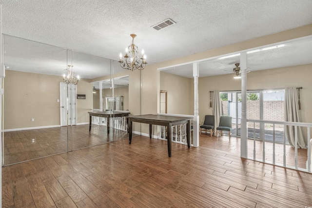 4701 N Kings Hwy Unit 8, Myrtle Beach, SC 29577 - empty room with a chandelier, wood finished floors, a textured ceiling, a ceiling fan, and ornate columns