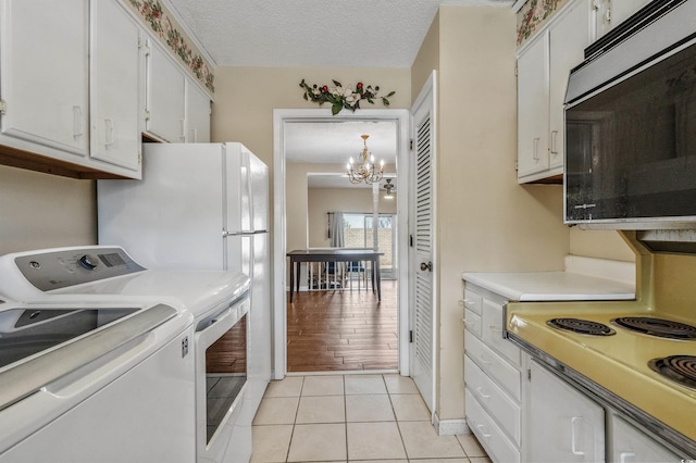 4701 N Kings Hwy Unit 8, Myrtle Beach, SC 29577 - kitchen with white cabinets, a chandelier, light countertops, light tile patterned flooring, and a textured ceiling