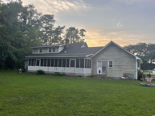 1872 Harris Short Cut Rd, Conway, SC 29526 - back of property at dusk featuring a sunroom, a chimney, a yard, and entry steps