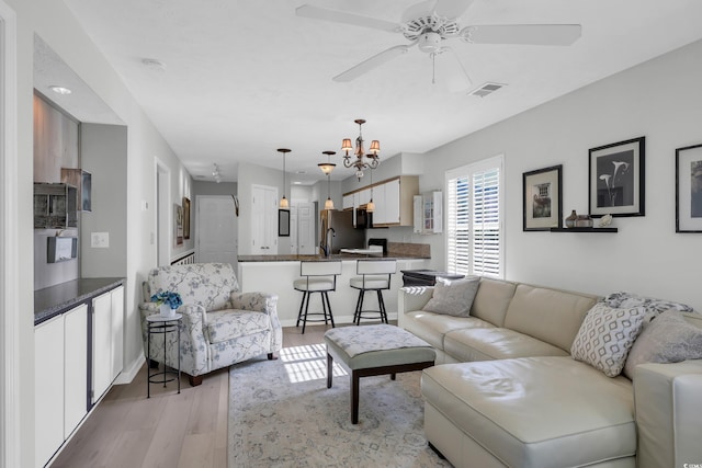 605 Waterway Village Blvd Unit 31A, Myrtle Beach, SC 29579 - living area with light wood-style flooring, ceiling fan, and a chandelier
