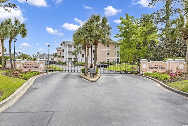 605 Waterway Village Blvd Unit 31A, Myrtle Beach, SC 29579 - view of asphalt street featuring a gate, street lights, a residential view, and curbs