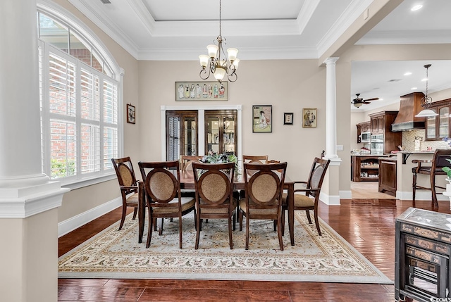 487 Trestle Way, Conway, SC 29526 - dining area featuring decorative columns, dark wood-style flooring, ornamental molding, a chandelier, and a tray ceiling