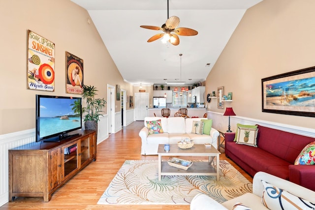 4865 Luster Leaf Cir Unit 402, Myrtle Beach, SC 29577 - living room with a wainscoted wall, light wood-style flooring, a ceiling fan, and high vaulted ceiling