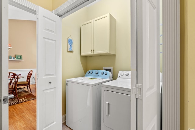 4865 Luster Leaf Cir Unit 402, Myrtle Beach, SC 29577 - laundry area with cabinet space, washer and dryer, and light wood-style floors