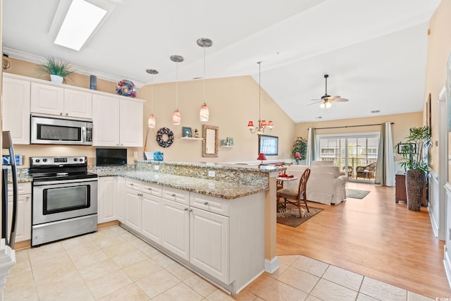 4865 Luster Leaf Cir Unit 402, Myrtle Beach, SC 29577 - kitchen featuring stainless steel appliances, light tile patterned floors, a peninsula, open floor plan, and ceiling fan