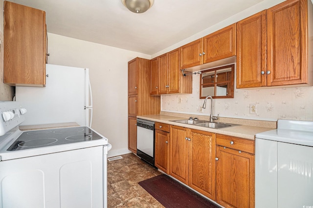 320 Edgewood Cir, Conway, SC 29527 - kitchen featuring white appliances, washer / dryer, brown cabinetry, and light countertops