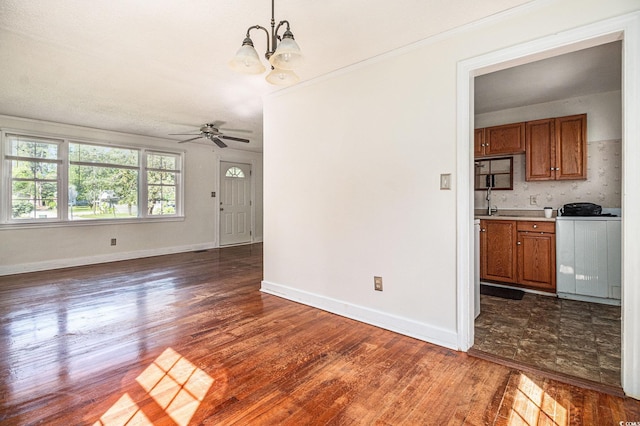 320 Edgewood Cir, Conway, SC 29527 - unfurnished dining area featuring dark wood finished floors, ceiling fan, a chandelier, crown molding, and washer / clothes dryer